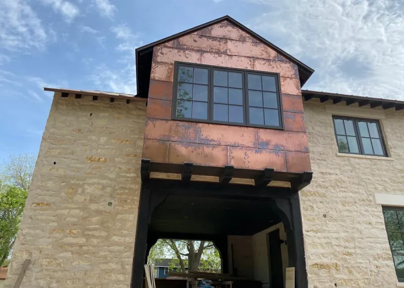 Copper metal panel facade on a stone building for Roof Repair in Metairie