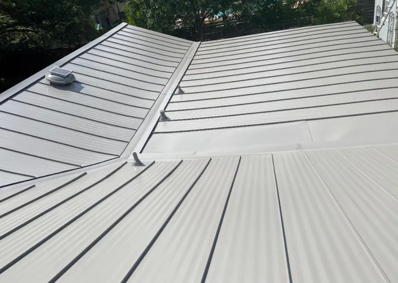 Solar attic fan installed on a metal roof for Roof Ventilation in Metairie